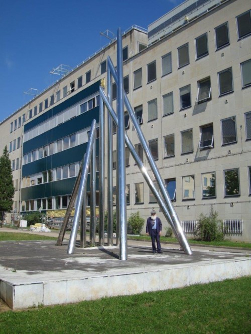 Yaacov Agam stands with newly renovated and set Tente sculpture at the University of Burgundy in Dijon, France.